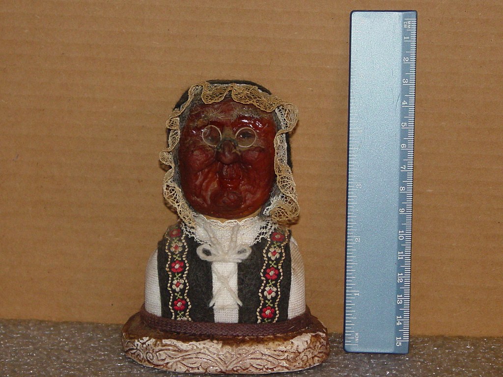 Apple head doll with ruler